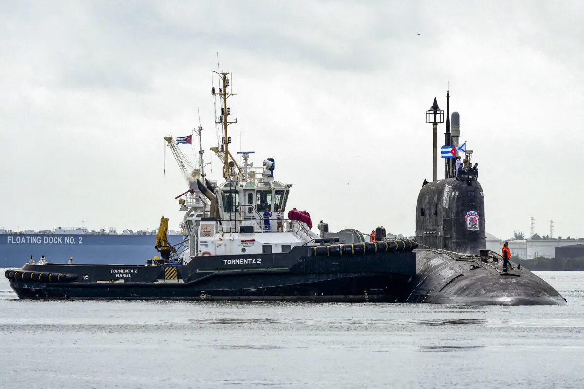 A tugboat maneuvers the Russian nuclear-powered cruise missile submarine Kazan as it docks in Havana’s harbor in Cuba, on June 12, 2024. (Alexandre Meneghini/Reuters)