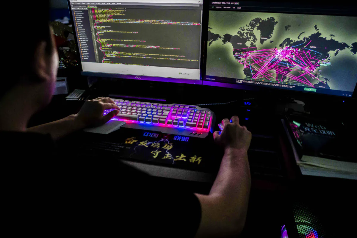 Prince, a member of the hacking group Red Hacker Alliance who refused to give his real name, uses a website that monitors global cyberattacks on his computer at their office in Dongguan, Guangdong Province, China, on Aug. 4, 2020. (Nicolas Asfouri/AFP via Getty Images)