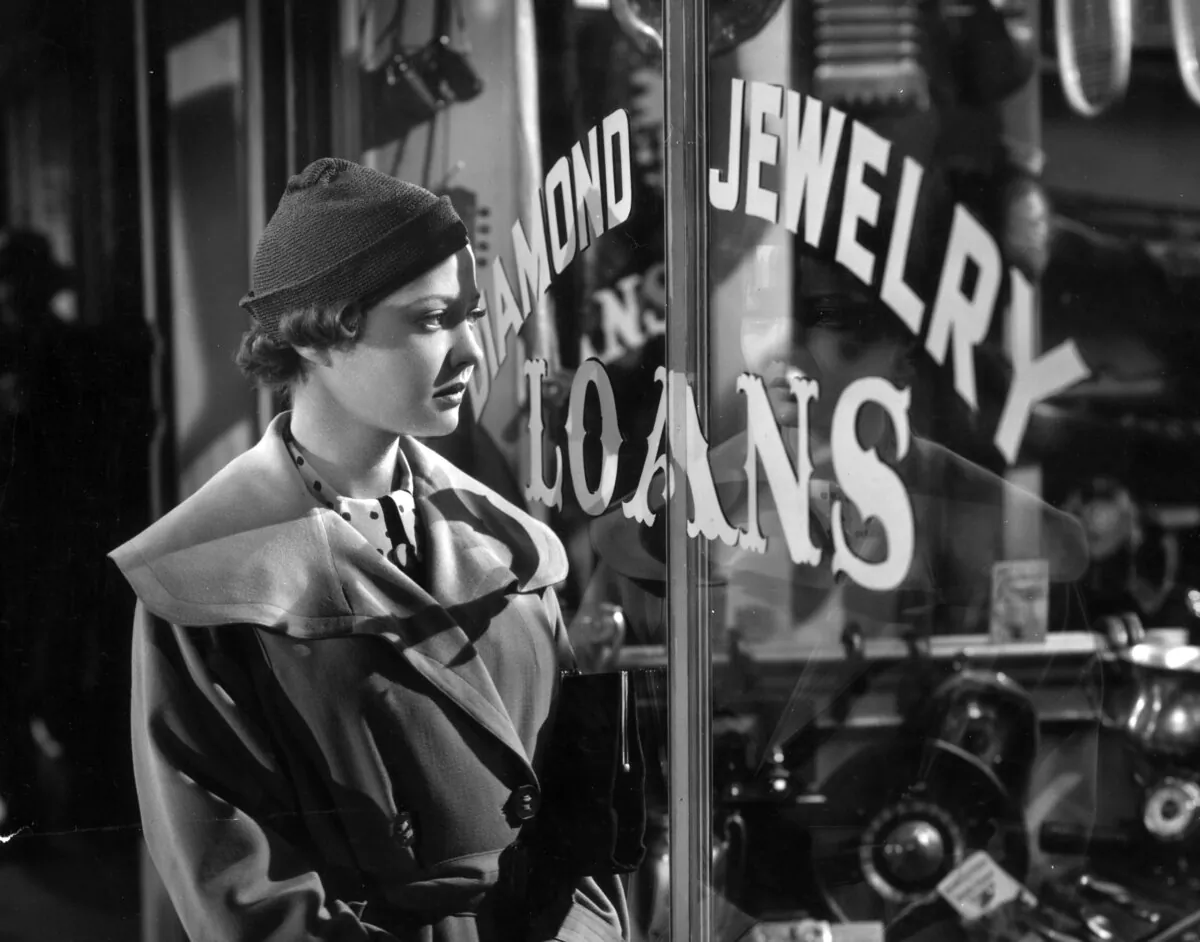 American actor Sylvia Sidney, wearing a trench coat, looks into a pawnshop window in a still from director Fritz Lang's film, "You Only Live Once."  (Hulton Archive/Getty Images)