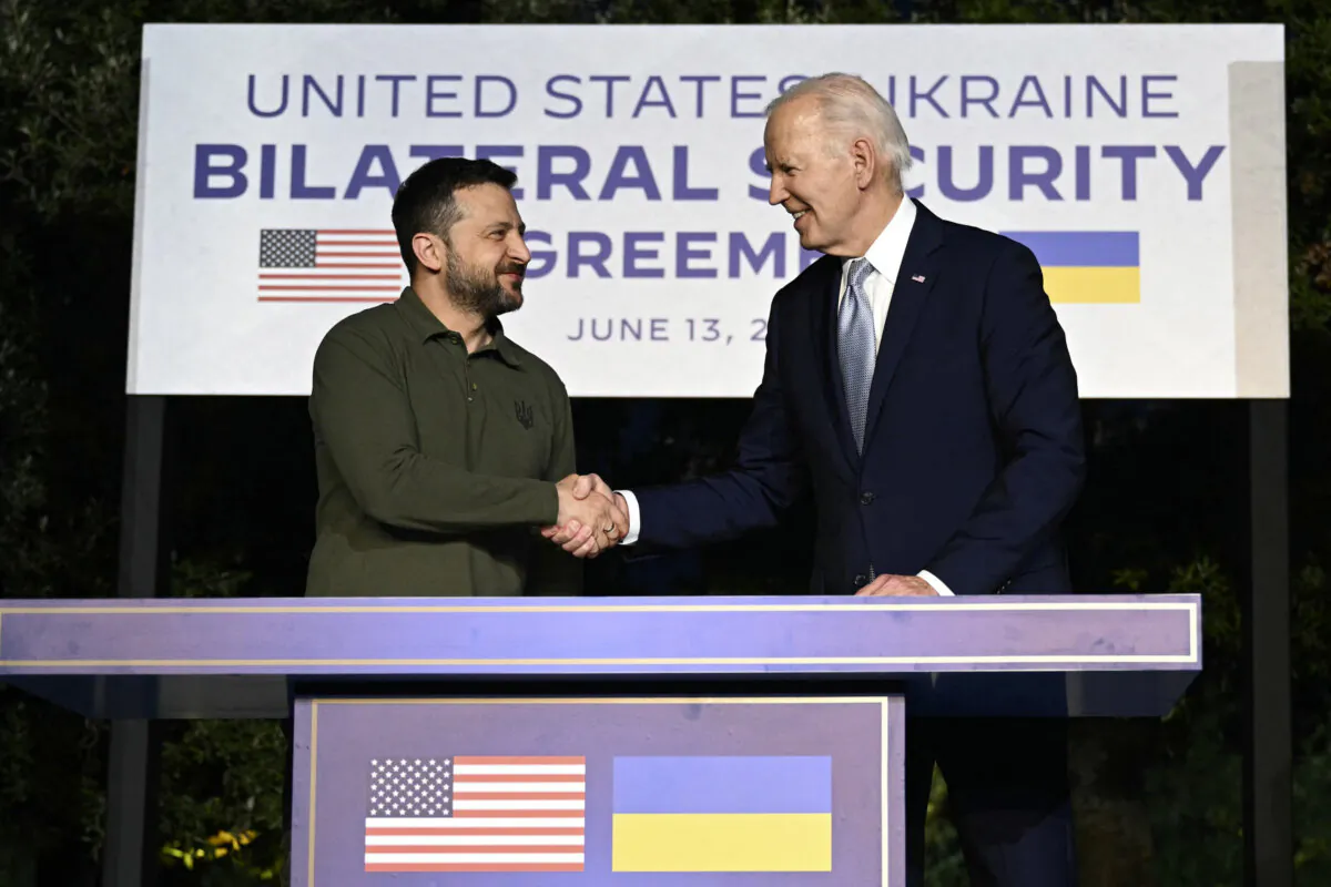 President Joe Biden and Ukrainian President Volodymyr Zelenskyy (L) shake hands after signing a bilateral security agreement on the sidelines of the G7 Summit in Italy's Apulia region, on June 13, 2024. (Mandel Ngan/AFP via Getty Images)