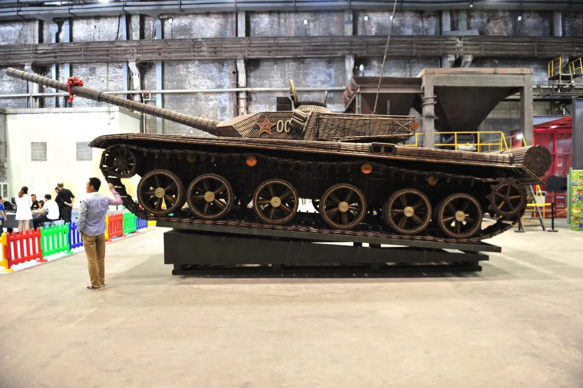 Visitors look at a full-scale replica of a ZTZ-99 tank displayed at the Chinese Industry Museum in Shenyang, Liaoning Province of China, on Sept. 15, 2013. (Getty Images)