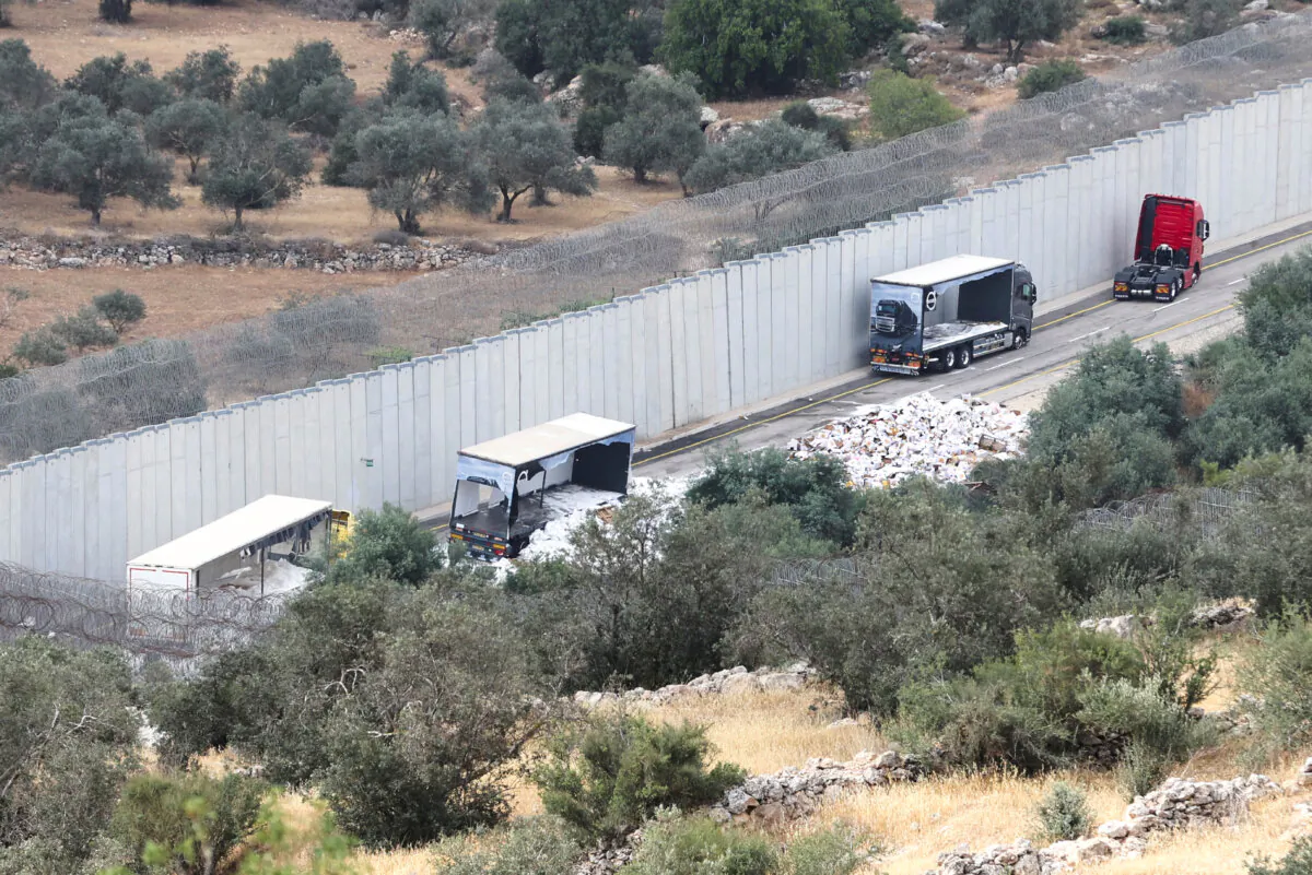 A view of trucks carrying aid to Gaza that were stopped after they were damaged by Israeli settlers near a checkpoint near Hebron in the West Bank on May 14, 2024. (Mussa Qawasma/Reuters)