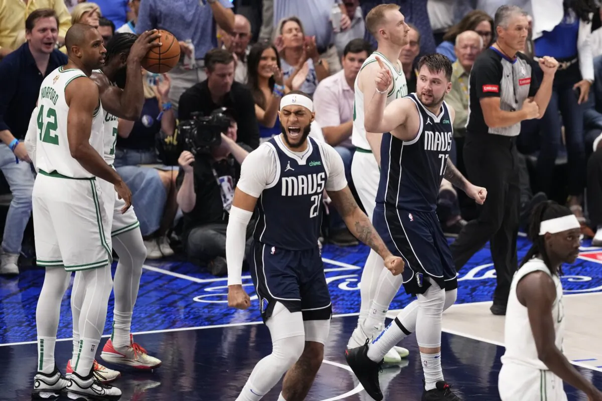Dallas Mavericks center Daniel Gafford (21) and guard Luka Doncic (77) celebrate a play during the first half in Game 4 of the NBA basketball finals against the Boston Celtics in Dallas on June 14, 2024. (Sam Hodde/AP Photo)