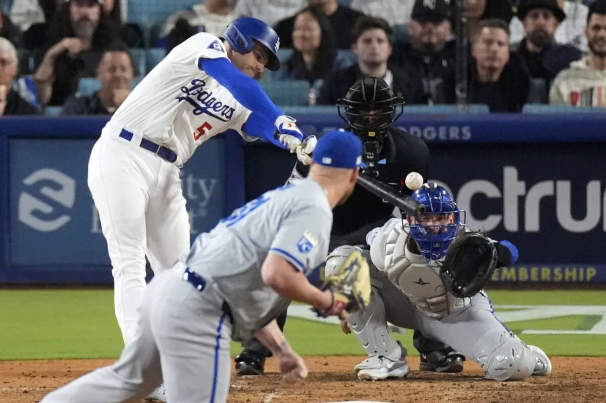 Los Angeles Dodgers' Freddie Freeman (5) hits an RBI single as Kansas City Royals relief pitcher Will Smith watches along with catcher Freddy Fermin (R) and home plate umpire Gabe Morales during the eighth inning of a baseball game in Los Angeles on June 14, 2024. (Mark J. Terrill/AP Photo)