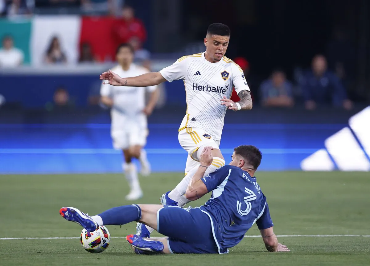 Gabriel Pec (11) of Los Angeles Galaxy controls the ball against Andreu Fontàs (3) of Sporting Kansas City in the first half in Carson, Calif., on June 15, 2024. (Ronald Martinez/Getty Images)