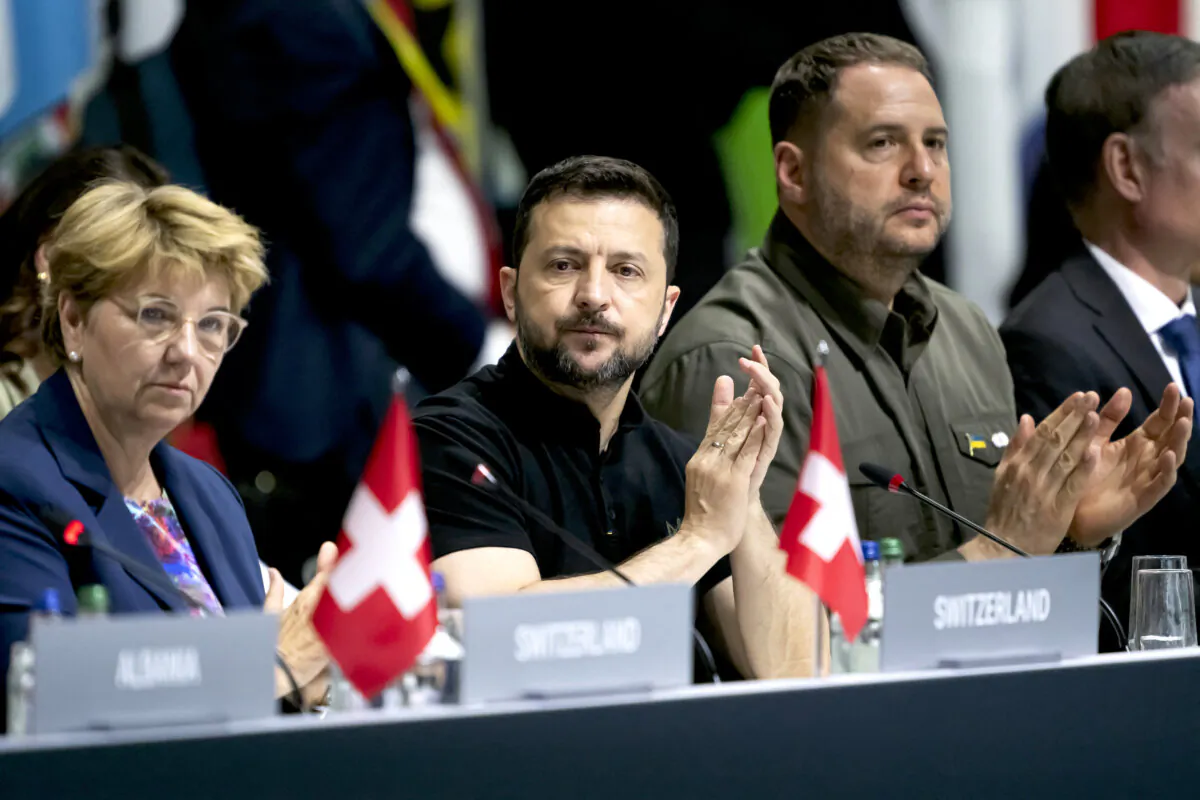Ukrainian President Volodymyr Zelenskyy (C) applauds next to Swiss Federal President Viola Amherd (L) and Ukraine Head of the presidential Office of Ukraine Andriy Yermak during a plenary session at the Summit on peace in Ukraine, at the luxury Burgenstock resort, near Lucerne, Switzerland, on June 16, 2024. (Alessandro Della Valle/Pool/AFP via Getty Images)