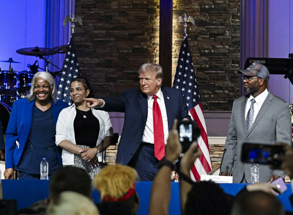 Republican presidential candidate and former President Donald Trump (C) participates in a community roundtable at the 180 Church in Detroit, Mich., on June 15, 2024. (Jim Watson/AFP via Getty Images)