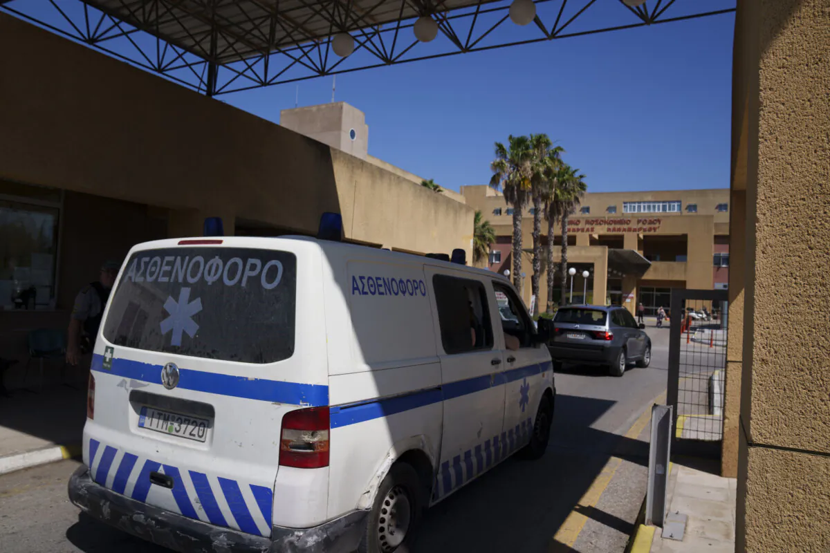 An ambulance drives through the entrance of a state-run hospital on the island of Rhodes, where the body of British TV presenter Michael Mosley was taken following his death while on vacation on the nearby island of Symi on June 10, 2024. (Petros Giannakouris/AP Photo)