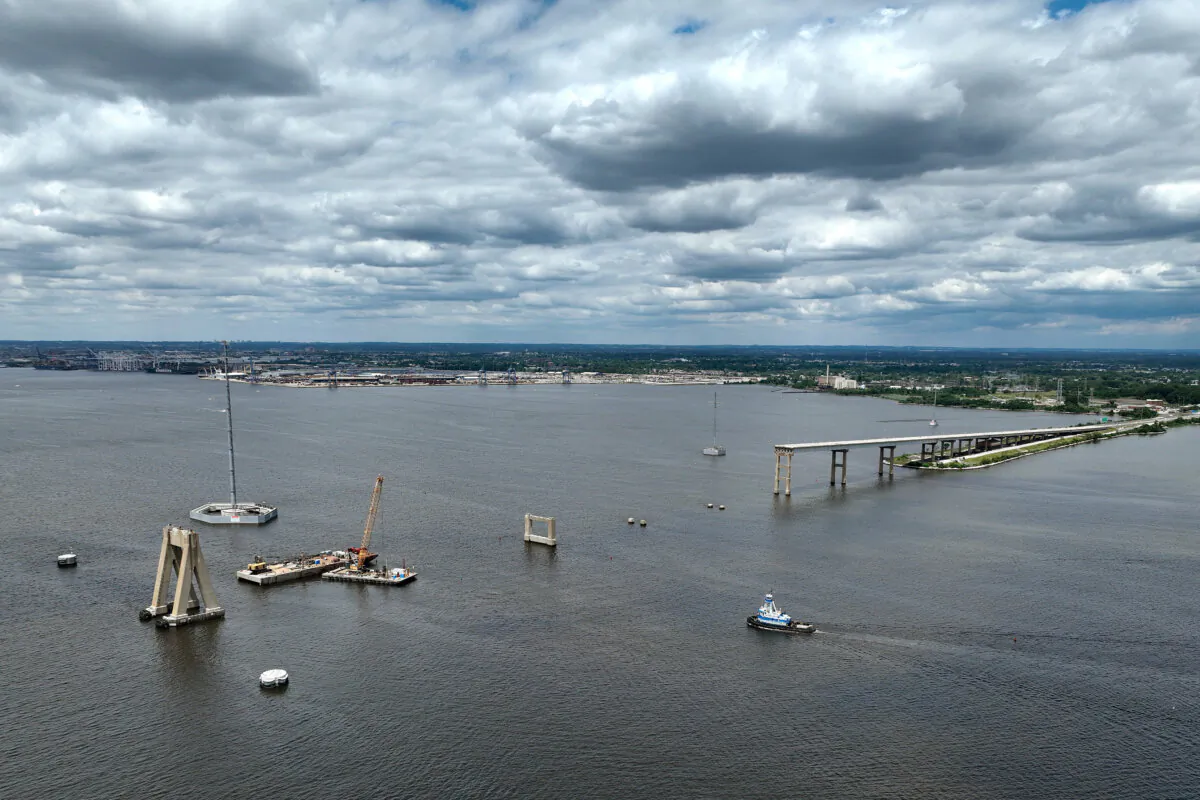 A tug boat travels towards the Port of Baltimore as salvage crews continue to clean up wreckage from the collapse of the Francis Scott Key Bridge in the Patapsco River in Baltimore on June 11, 2024. (Kevin Dietsch/Getty Images)