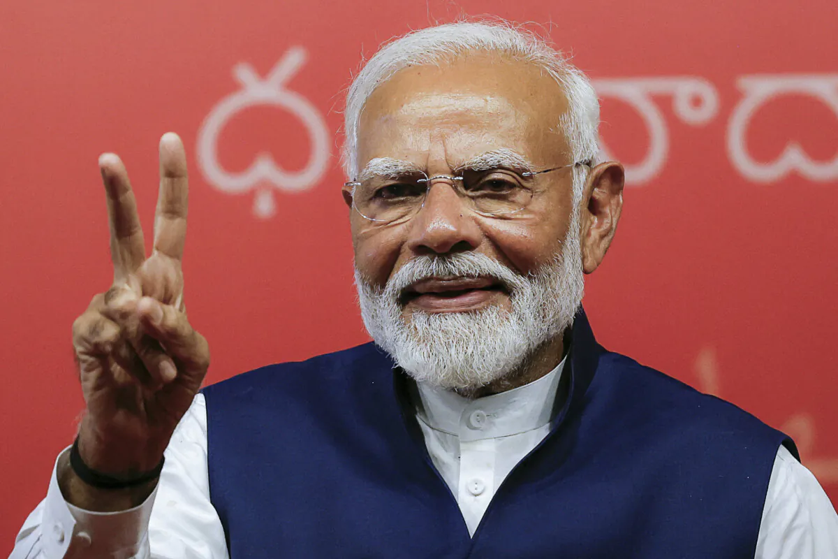 Indian Prime Minister Narendra Modi gives a victory symbol at the Bharatiya Janata Party (BJP) headquarters in New Delhi on June 4, 2024. (Adnan Abidi/Reuters)