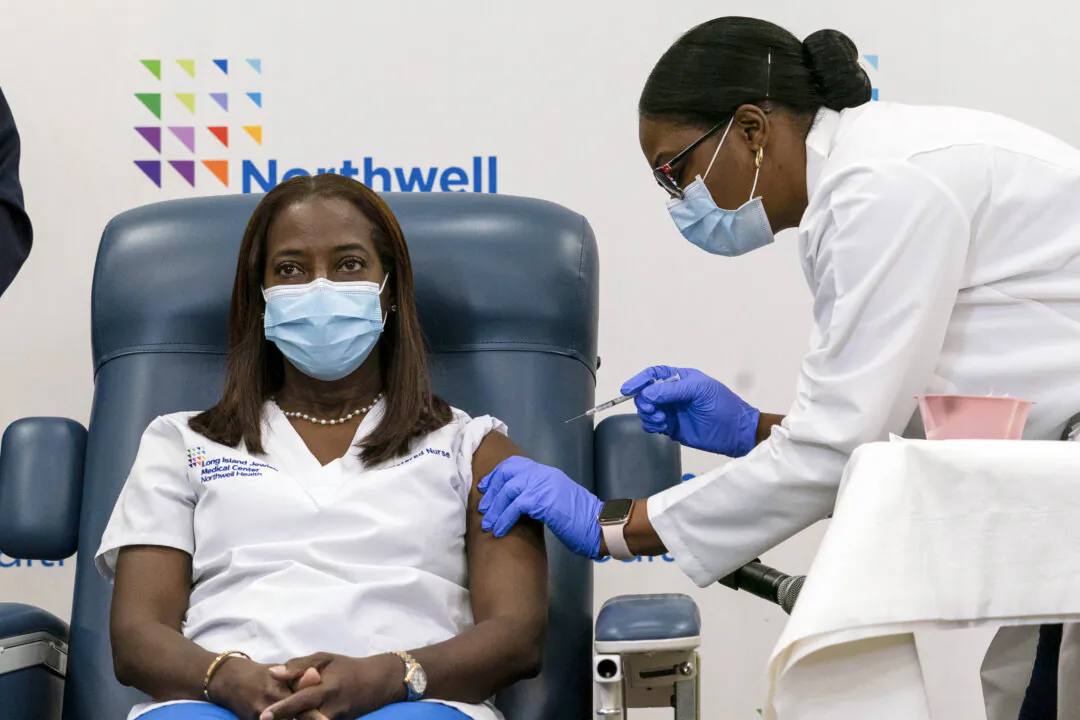 A nurse at the Long Island Jewish Medical Center is injected with the COVID-19 vaccine in Queens, N.Y., on Dec.14, 2020. (Mark Lennihan - Pool/Getty Images)