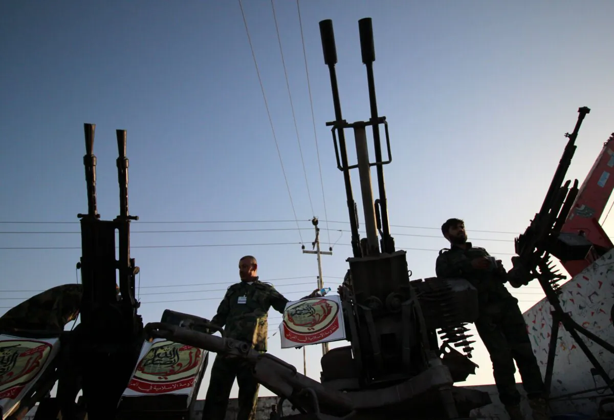 Fighters of the Harakat Ansar Allah al-Awfiya Shiite group parade with their weapons in the southern Iraqi city of Basra on June 16, 2015.     (Haidar Mohammed Ali/AFP via Getty Images)