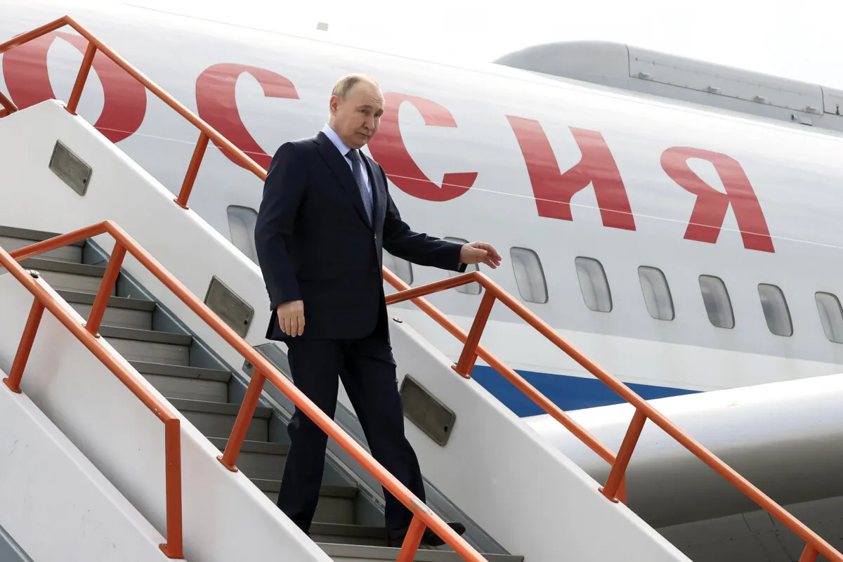 Russian President Vladimir Putin goes down the stairs upon his arrival at the airport of Yakutsk, republic of Sakha, also known as Yakutia, Russia Far East, Russia, on June 18, 2024. (Sergei Karpukhin/Sputnik, Kremlin Pool Photo via AP)