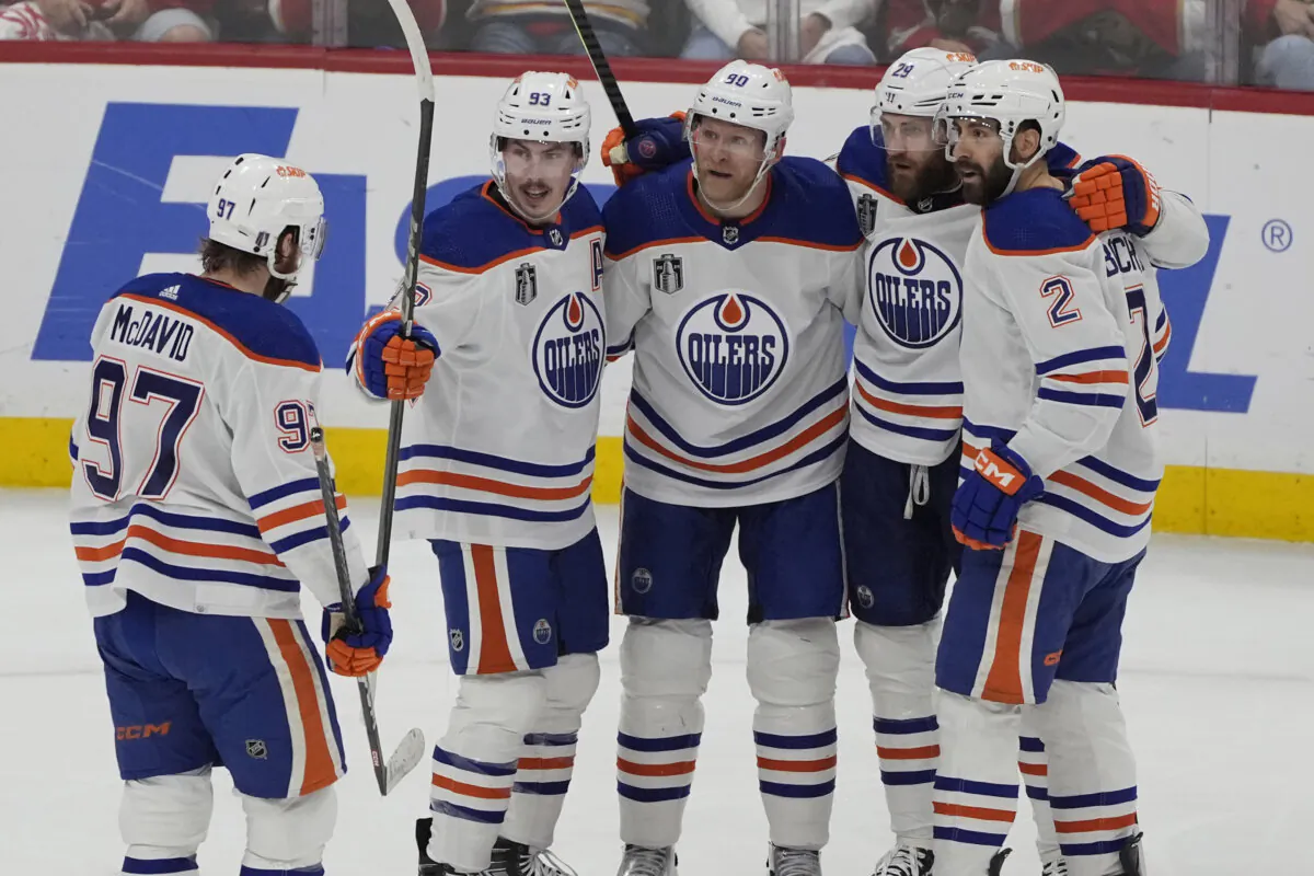 Edmonton Oilers players surround Corey Perry (90) after he scored a goal during Game 5 of the Stanley Cup Final against the Florida Panthers in Sunrise, Fla., on June 18, 2024. (Rebecca Blackwell/AP Photo)