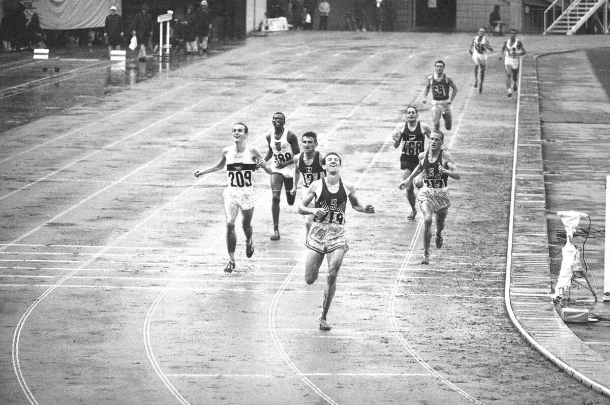Bob Schul hits the tape to win the 5,000 meter run at the Olympic Games in Tokyo on Oct. 18, 1964. (AP Photo)