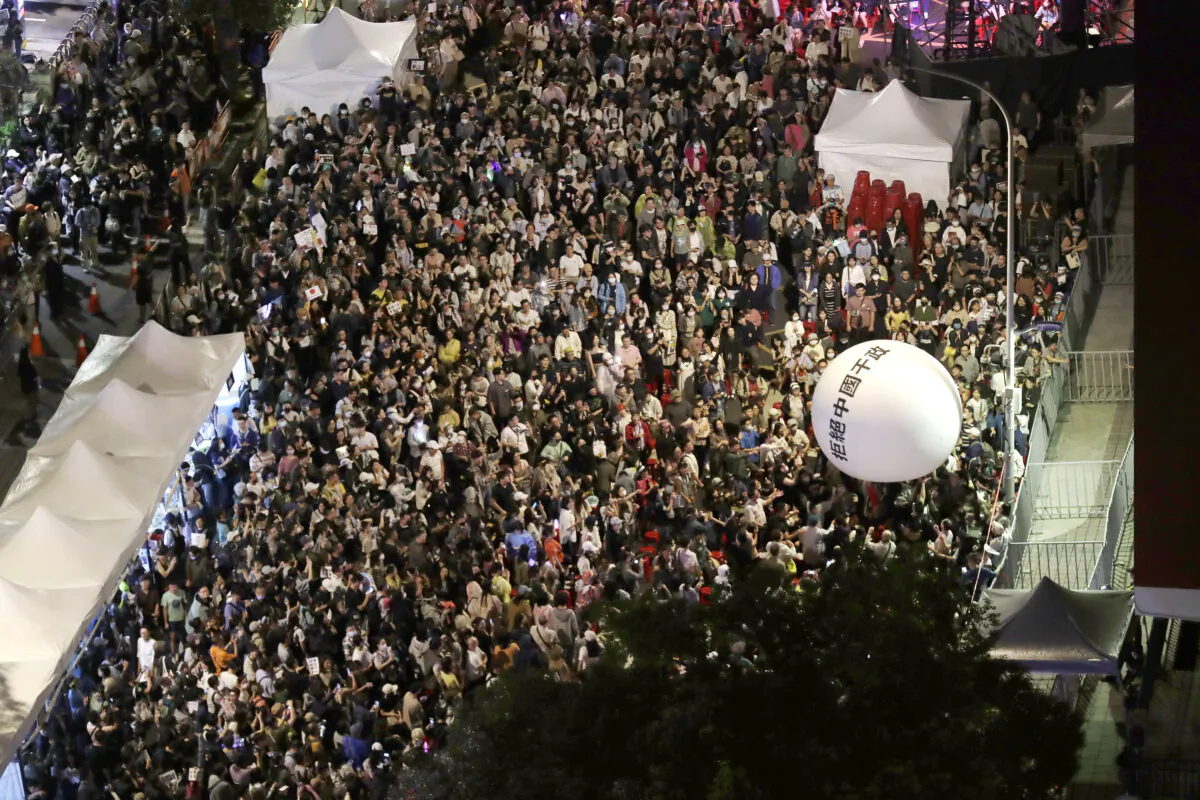 Supporters of the ruling Democratic Progressive Party (DPP) gather and push an ball reading ''Reject China's Interference In Politics'' outside of the legislative building in Taipei, Taiwan, on May 28, 2024. (Chiang Ying-ying/AP Photo)