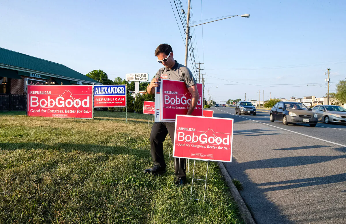 Supporter Phil Hamilton places campaign signs for Rep. Bob Good, a candidate in the Republican primary for the Virginia's 5th Congressional District, along Timberlake Road in Lynchburg, Va., on June 18, 2024. (AP Photo/P. Kevin Morley)