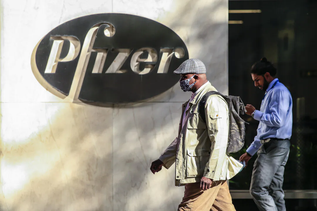 People walk by the Pfizer world headquarters in New York City on Nov. 9, 2020. (Kena Betancur/AFP via Getty Images)