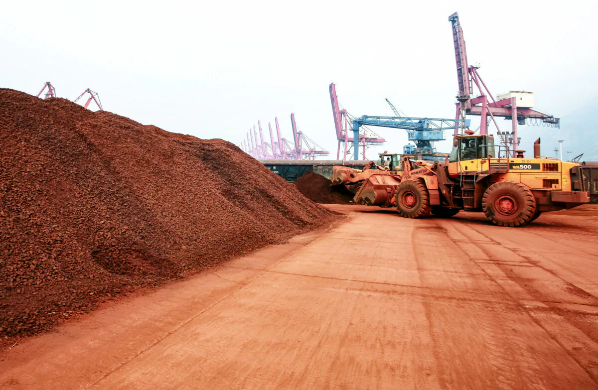 A loader shifts soil containing rare-earth minerals, at a port in Lianyungang, Jiangsu Province, China, on Sept. 5, 2010. (AFP via Getty Images)