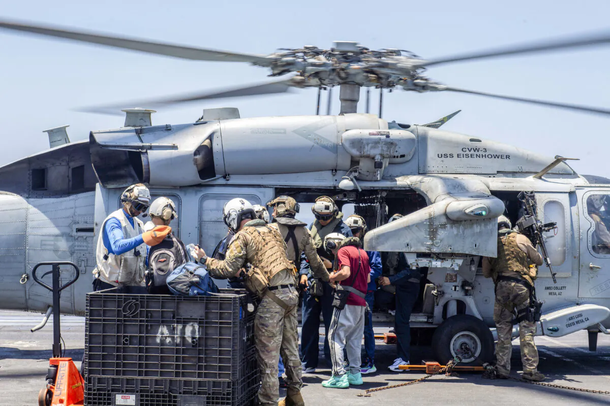 Sailors from the Dwight D. Eisenhower Carrier Strike Group assist distressed mariners rescued from the Liberian-flagged, Greek-owned bulk carrier M/V Tutor that was attacked by Houthis, in the Red Sea, on June 15, 2024. (U.S. Naval Forces Central Command/U.S. 5th Fleet/Handout via REUTERS/File Photo)