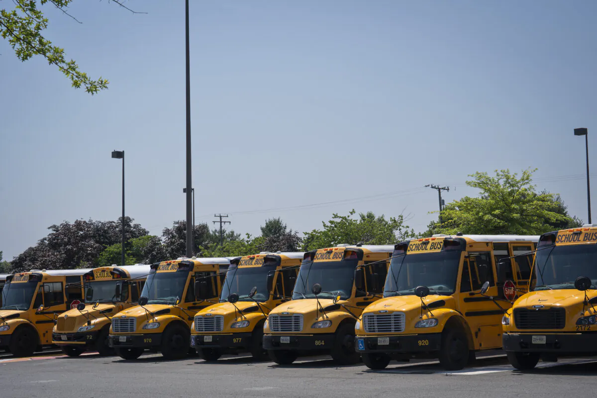 School buses at Stone Bridge High School in Ashburn, Va., on June 18, 2024. (Madalina Vasiliu/The Epoch Times)