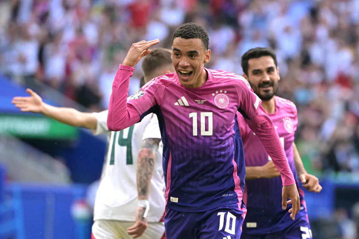 Germany's midfielder #10 Jamal Musiala (C) celebrates after scoring the opening goal during the UEFA Euro 2024 Group A football match between Germany and Hungary at the Stuttgart Arena in Stuttgart, Germany, on June 19, 2024. (Damien Meyer/AFP via Getty Images)