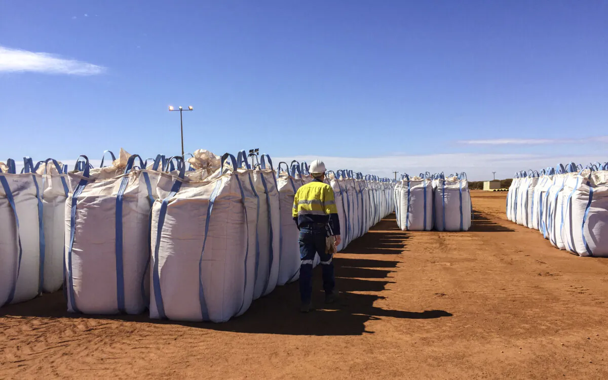A Lynas Corp worker walks past sacks of rare earth concentrate waiting to be shipped to Malaysia, at Mount Weld, northeast of Perth, Australia, on Aug. 23, 2019. (Melanie Burton/File Photo/Reuters)