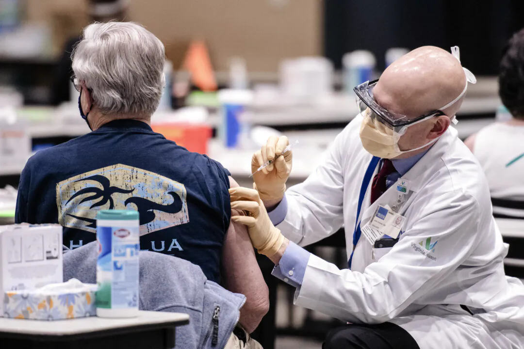 A man receives a dose of a COVID-19 vaccine in Seattle, Wash., on Jan. 24, 2021. (Grant Hindsley/AFP via Getty Images)