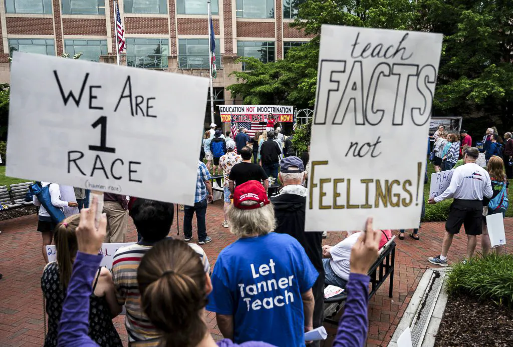 Demonstrators hold up signs during a rally against "critical race theory" (CRT) being taught in schools at the Loudoun County Government center in Leesburg, Va., on June 12, 2021. (Andrew Caballero-Reynolds / AFP via Getty Images)