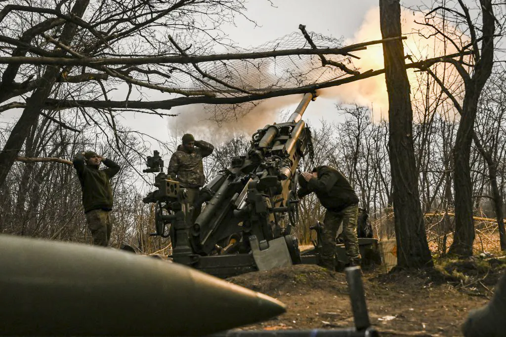 Ukrainian soldiers fire a M777 howitzer at Russian positions near Bakhmut, eastern Ukraine, on March 17, 2023. (Aris Messinis/AFP via Getty Images)