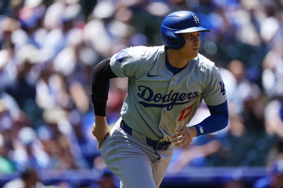 The Los Angeles Dodgers' Shohei Ohtani, who homered earlier in the game, heads to first base after drawing a walk against the Colorado Rockies in Denver on June 20, 2024. (David Zalubowski/AP Photo)