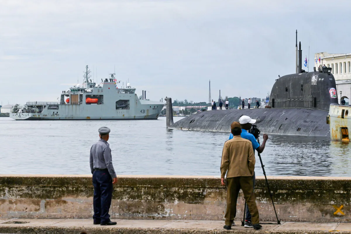 People watch Canadian navy patrol boat HMCS Margaret Brooke passing by Russian nuclear-powered cruise missile submarine Kazan as it enters Havana Harbor, Cuba, on June 14, 2024. (Reuters/Stringer)