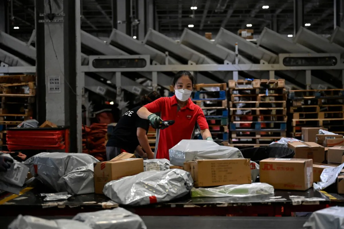 Workers sort packages for delivery at a JD.com warehouse in Beijing in a file photo. (Jade Gao/AFP via Getty Images)