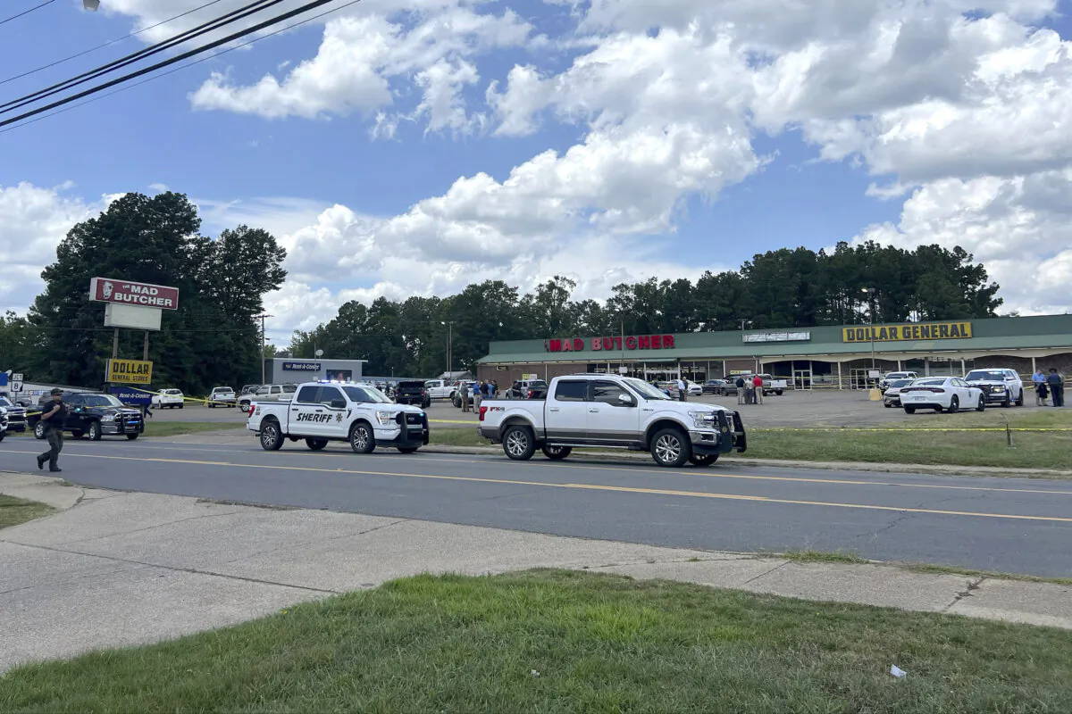 Police vehicles remain on the scene of a shooting at the Mad Butcher grocery store in Frodyce, Ark., on June 21, 2024. (Ainsley Platt/Arkansas Democrat-Gazette via AP)