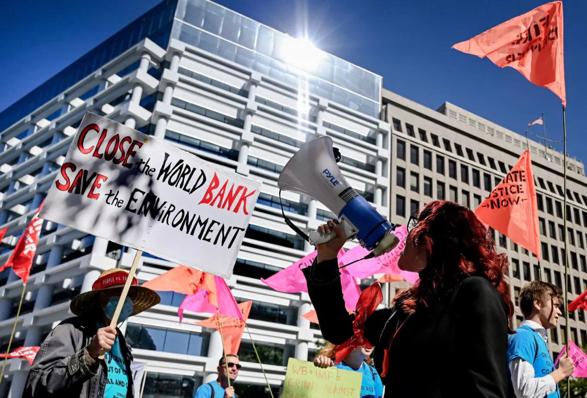 Climate activists protest outside the World Bank headquarters against fossil fuel projects during the IMF and World Bank annual meetings in Washington on Oct. 14, 2022. (Olivier Douliery/AFP via Getty Images)