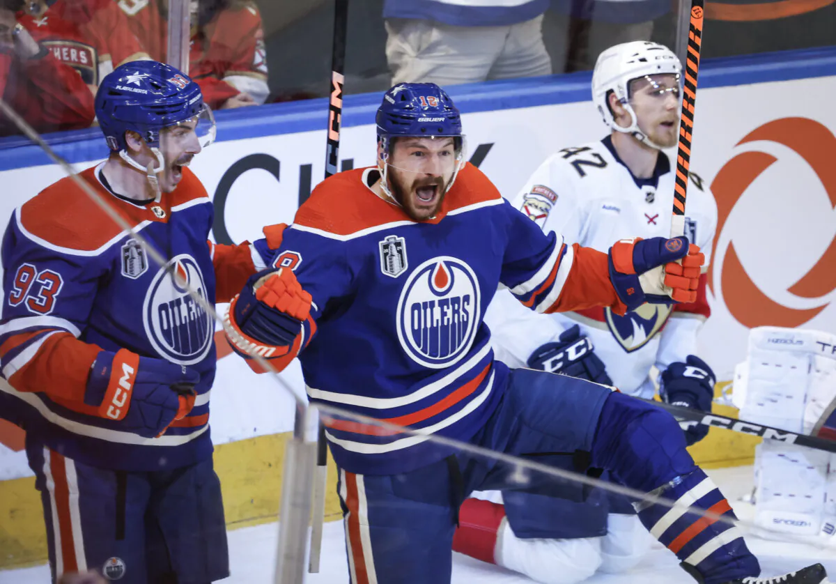 Edmonton Oilers' Zach Hyman (18) celebrates his goal against the Florida Panthers with Ryan Nugent-Hopkins (93) as Panthers' Gustav Forsling (42) skates past during the second period of Game 6 of the Stanley Cup Final, in Edmonton on June 21, 2024. (Jeff McIntosh/The Canadian Press via AP)