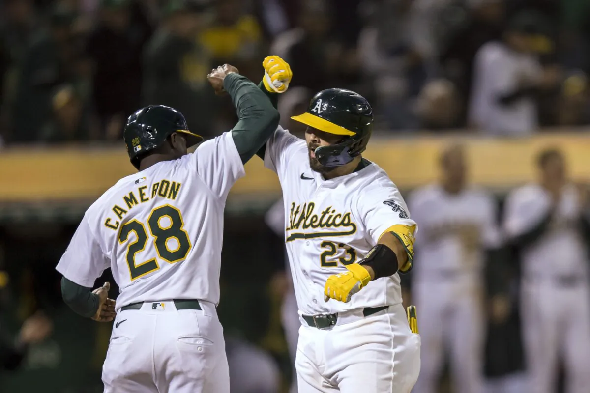 Oakland Athletics' Shea Langeliers is congratulated by Daz Cameron (28) after he hit a two-run home run against the Minnesota Twins during the eighth inning of a baseball game in Oakland, Calif., on June 21, 2024. (John Hefti/AP Photo)