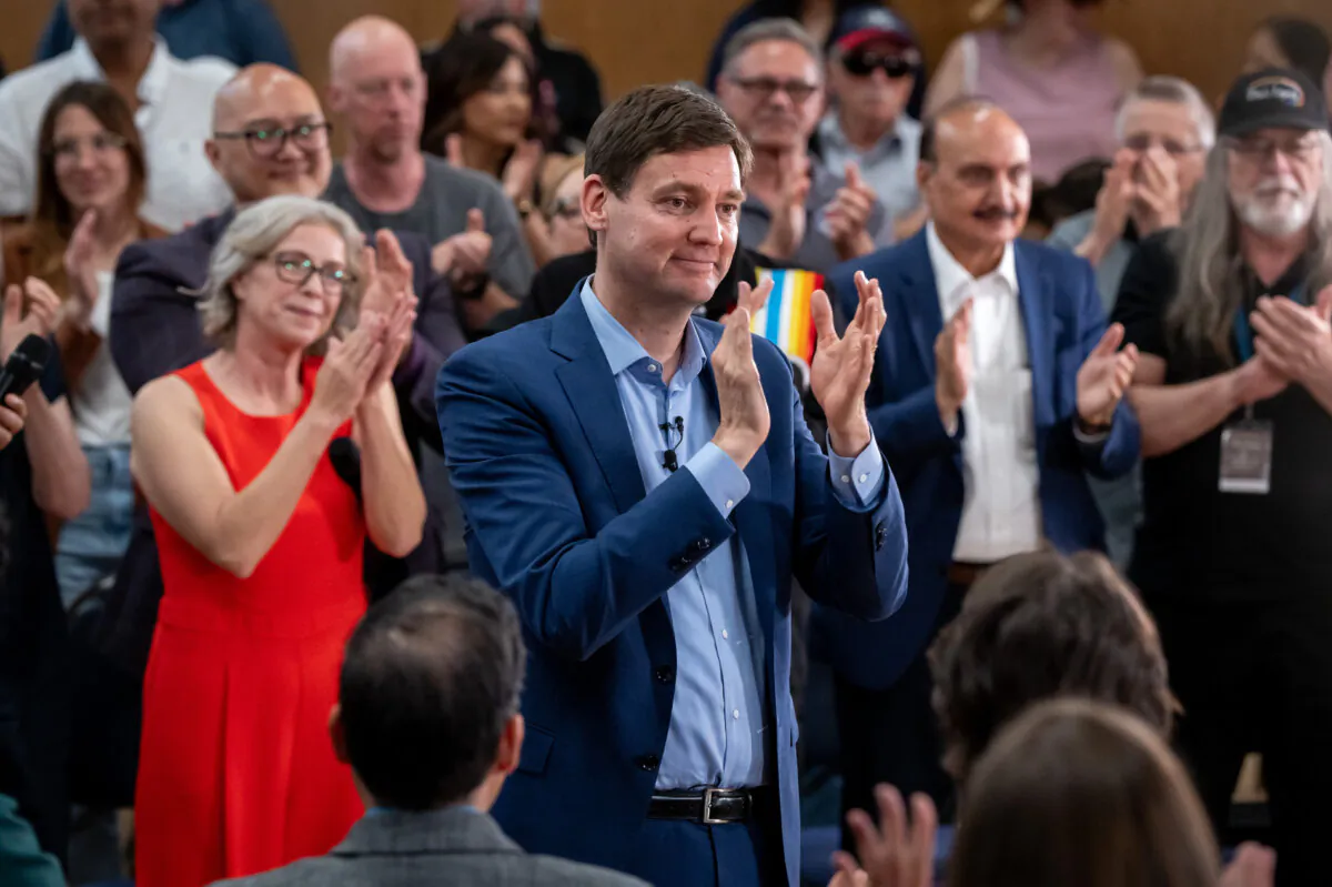 B.C. Premier David Eby claps with the crowd after a B.C. NDP campaign event in Vancouver on June. 20, 2024. (The Canadian Press/Ethan Cairns)