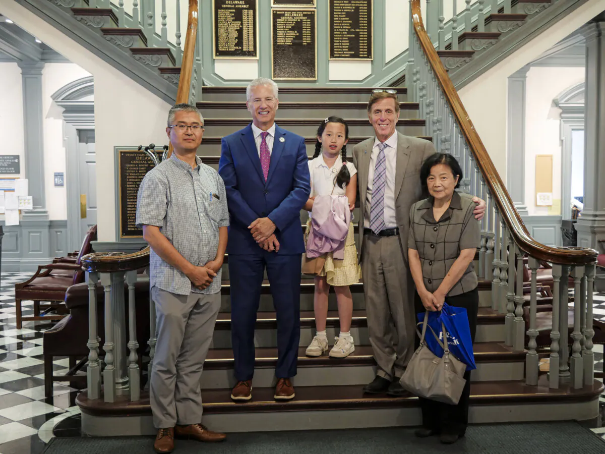 Delaware House Reps. Michael Romane (R2) and Lyndon Yearick (L2) pose for a photo with Falun Gong practitioners on June 20, 2024. (Andrew Li/The Epoch Times)