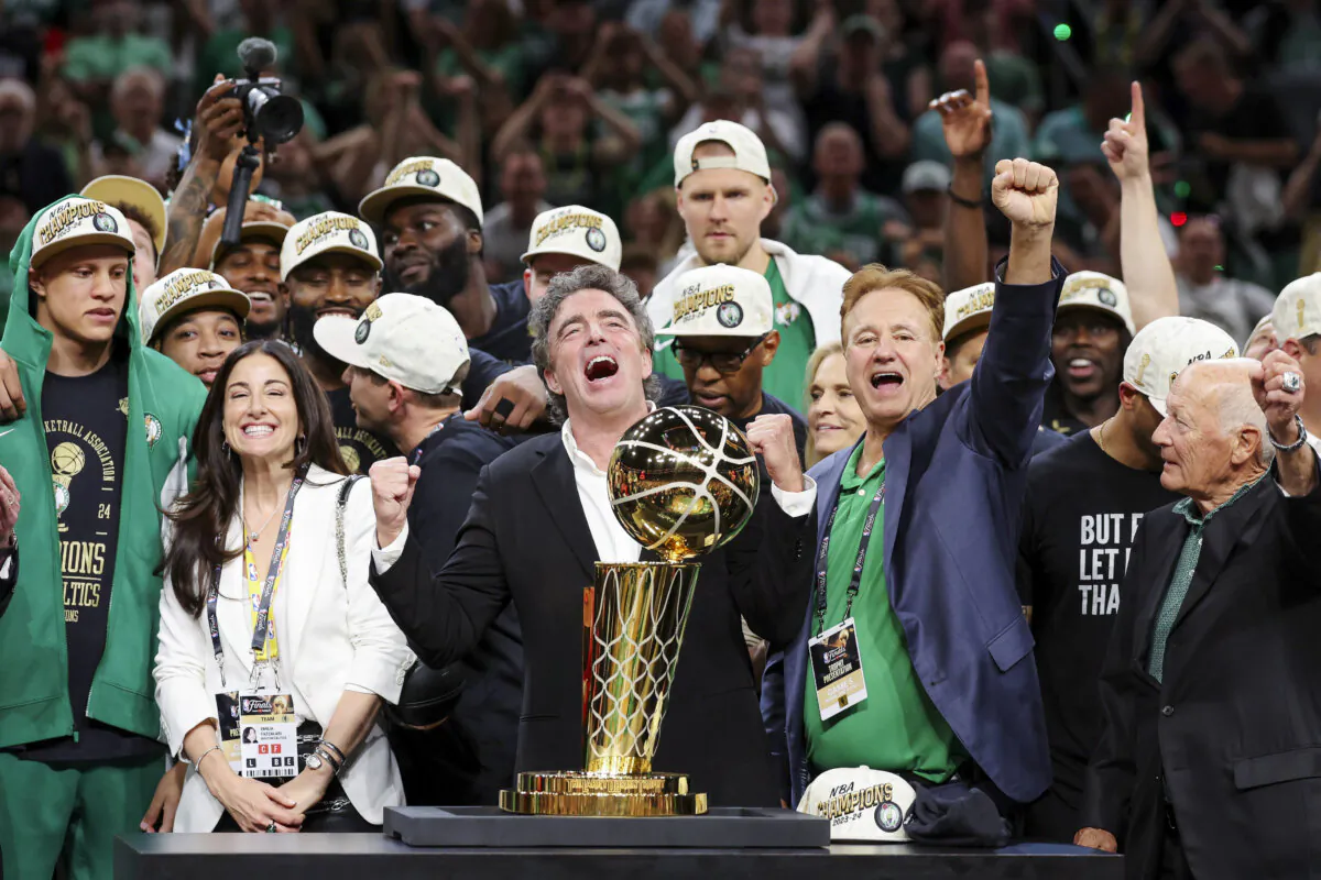Majority owner Wyc Grousbeck of the Boston Celtics celebrates with the Larry O’Brien Championship Trophy after Boston's 106-88 win against the Dallas Mavericks in Game Five of the 2024 NBA Finals in Boston on June 17, 2024. (Elsa/Getty Images)