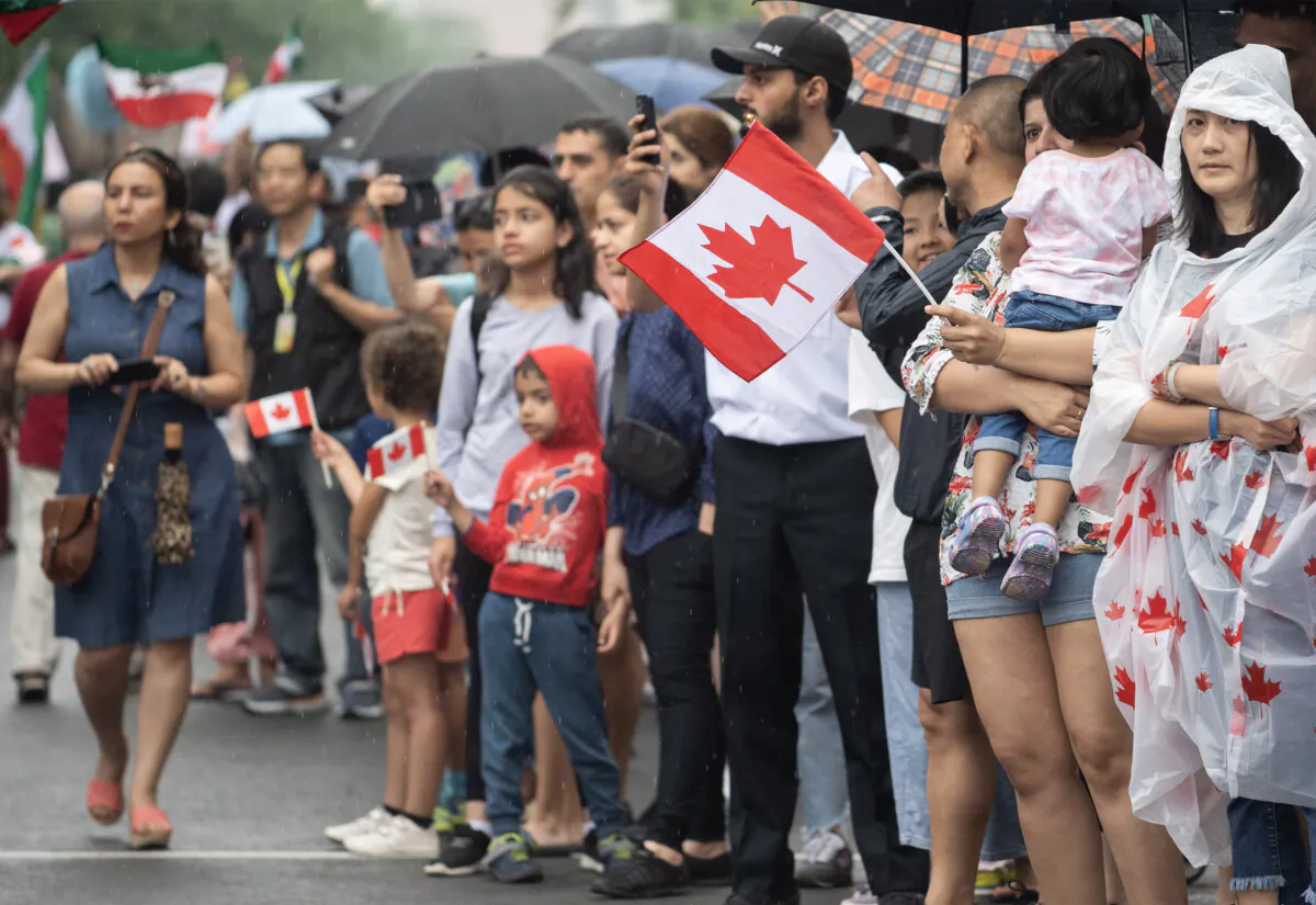 Members of the crowd look on during a Canada Day parade in Montreal, on July 1, 2023. (The Canadian Press/Graham Hughes)