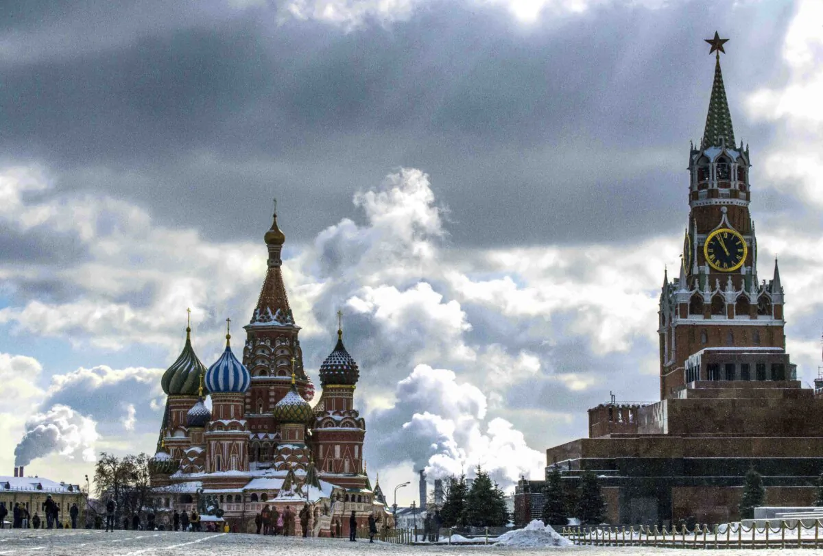 People walk in front of St. Basil's Cathedral and the Kremlin on Red Square in Moscow on Mar. 16, 2018.
(Mladen Antonov/AFP via Getty Images)