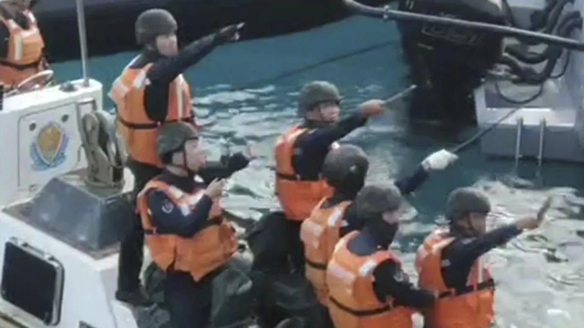 Chinese Coast Guard personnel hold knives and machetes as they approach Philippine troops on a resupply mission in the Second Thomas Shoal at the disputed South China Sea on June 17, 2024. (Armed Forces of the Philippines via AP)
