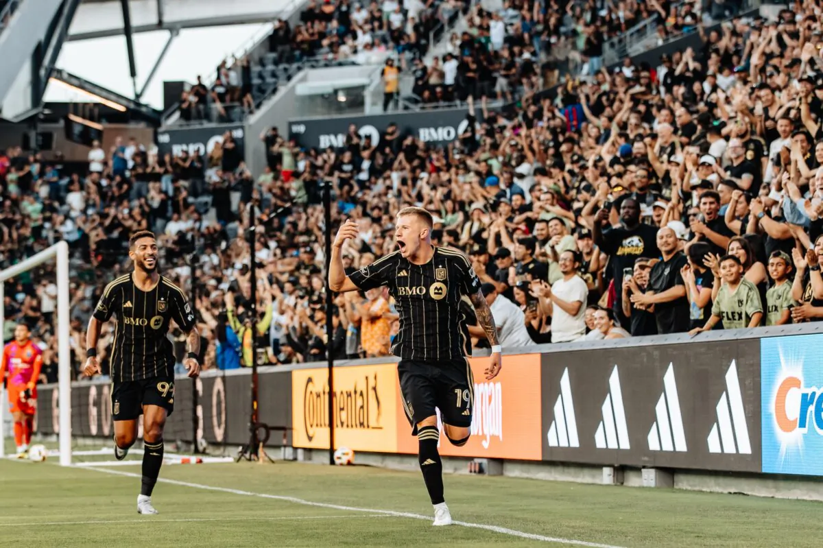 LAFC midfielder Mateusz Bogusz (19) celebrates the opening goal with Denis Bouanga (99), who provided the assist, in a soccer match against the San Jose Earthquakes in Los Angeles on June 22, 2024. (Courtesy of LAFC via The Epoch Times)