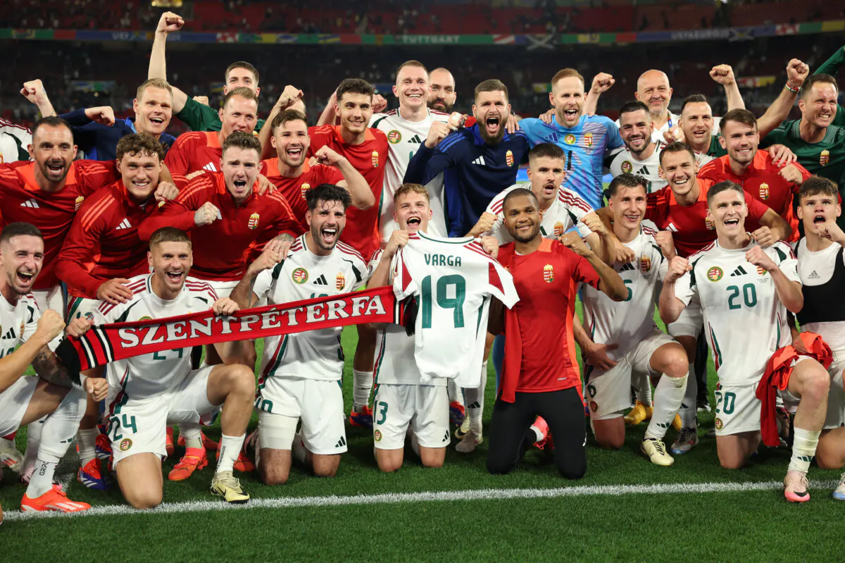 Players of Hungary pose for a photo as Andras Schafer of Hungary holds up the shirt of Barnabas Varga (not pictured), who left the field following an injury, after defeating Scotland during the UEFA EURO 2024 group stage match between Scotland and Hungary at Stuttgart Arena in Stuttgart, Germany, on June 23, 2024. (Carl Recine/Getty Images)