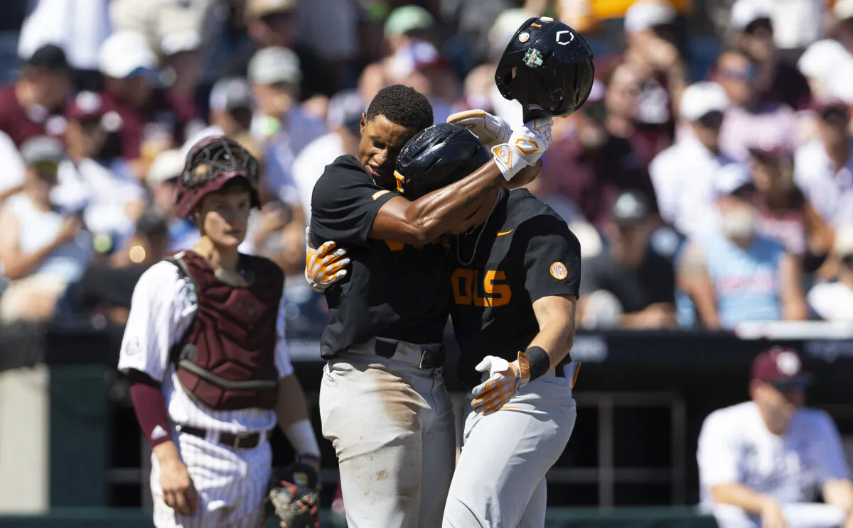 Tennessee's Dylan Dreiling (R) receives a hug from teammate Christian Moore after hitting a go-ahead home run against Texas A&M in Game 2 of the College World Series finals in Omaha, Neb., on June 23, 2024. (Rebecca S. Gratz/AP Photo)