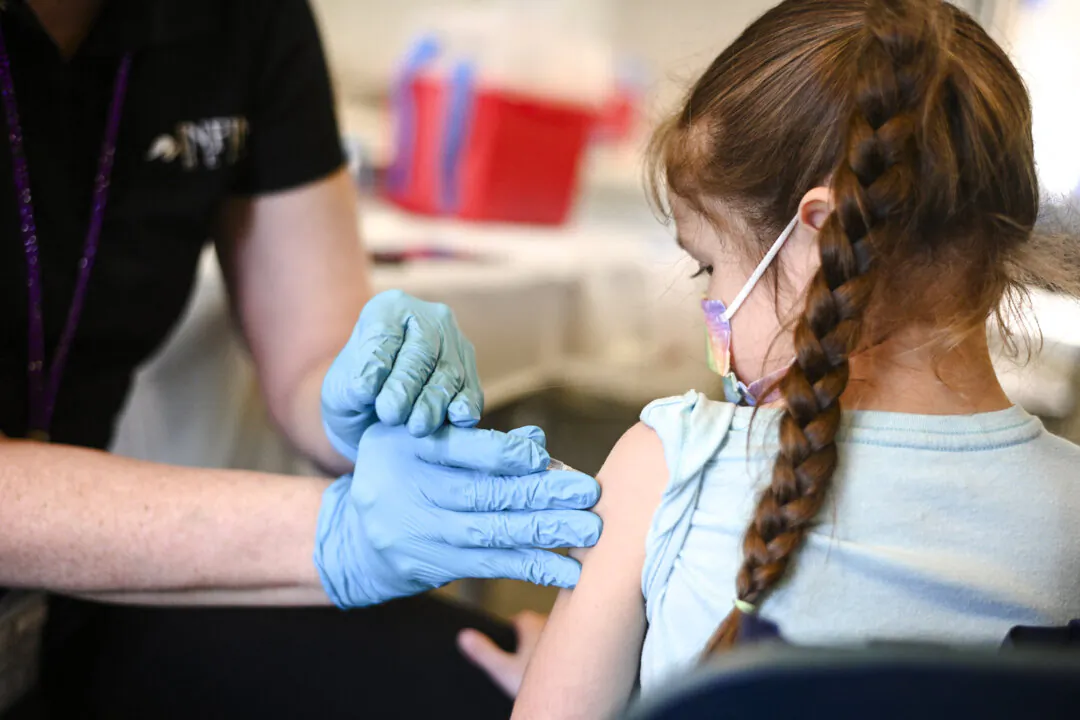 A nurse administers a pediatric dose of the COVID-19 vaccine to a girl in Los Angeles on Jan. 19, 2022. (ROBYN BECK/AFP via Getty Images)