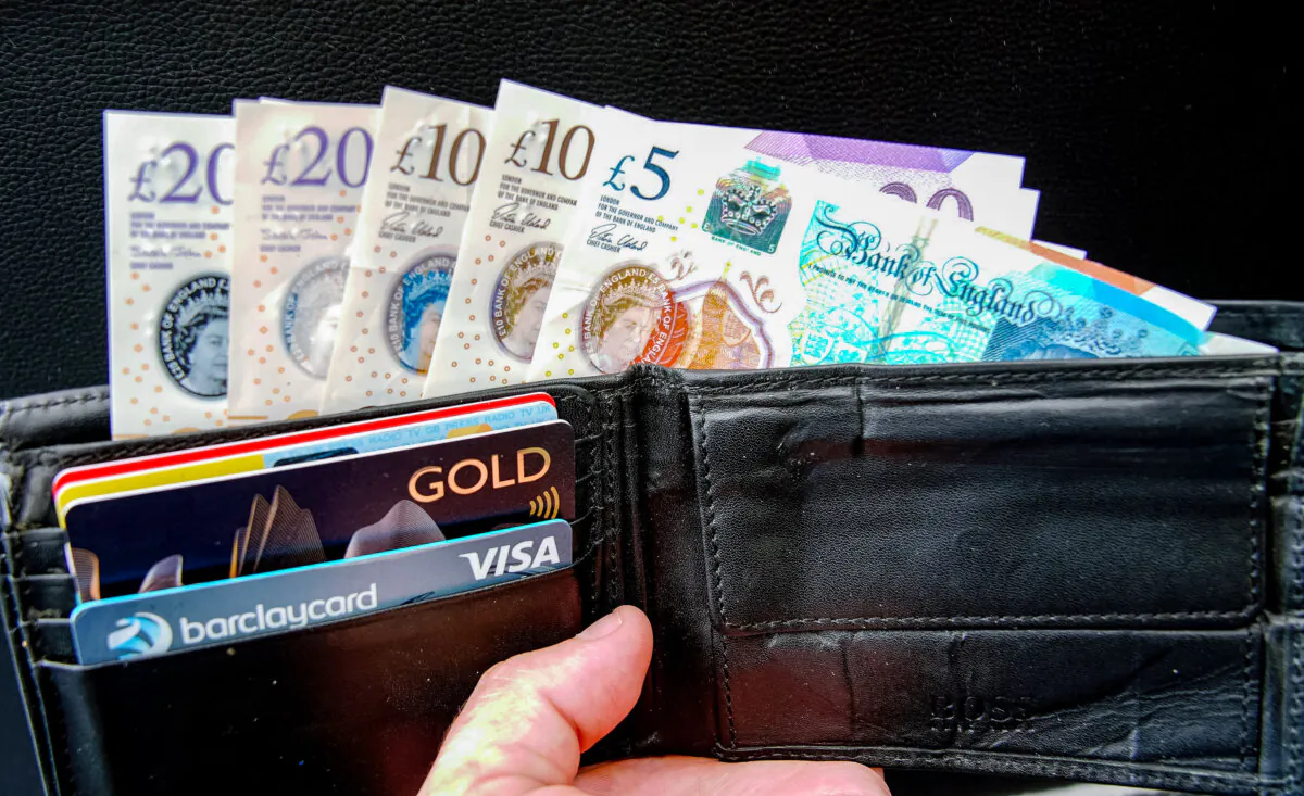 Undated file photo of a wallet with bank cards and sterling pound notes. (Peter Byrne/PA)