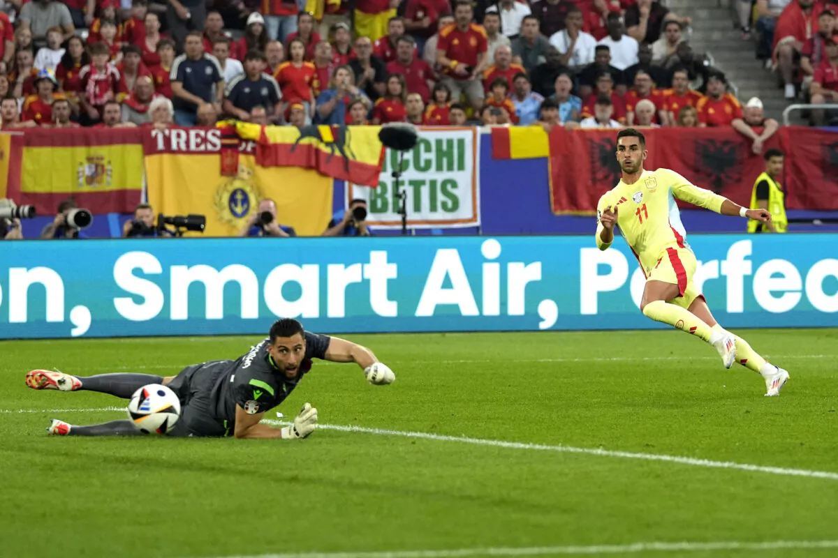 Spain's Ferran Torres (R) scores his side's opening goal during a Group B match between Albania and Spain at the Euro 2024 soccer tournament in Duesseldorf, Germany, on June 24, 2024. (Martin Meissner/AP Photo)