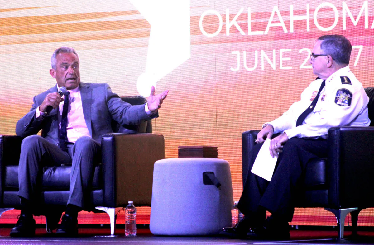 Robert F. Kennedy Jr., (L) answers a question while National Sheriff's Association (NSA) President Sheriff Greg Champagne, of St. Charles Parish, La., listens during the National Sheriff's Association Annual Meeting on June 24, 2024 in Oklahoma City. (Michael Clements/The Epoch Times)